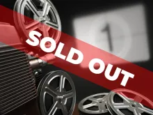 The words "SOLD OUT" displayed over a projector pointed at a screen